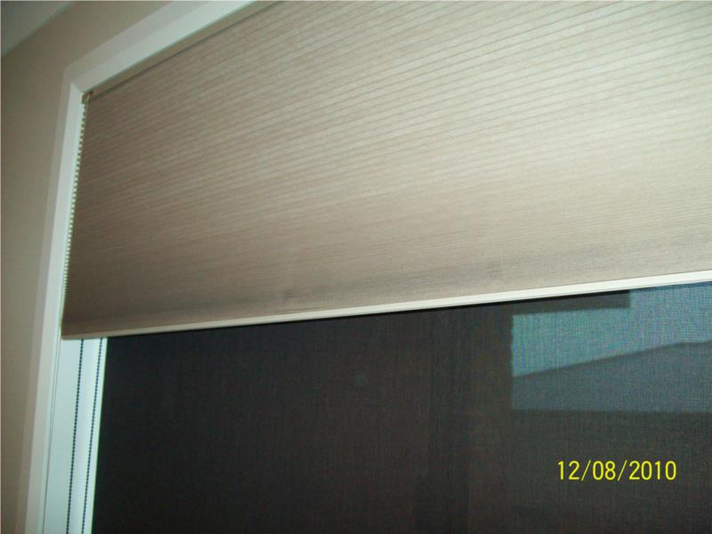 Blockout honeycomb blind in front Charcoal sunscreen behind