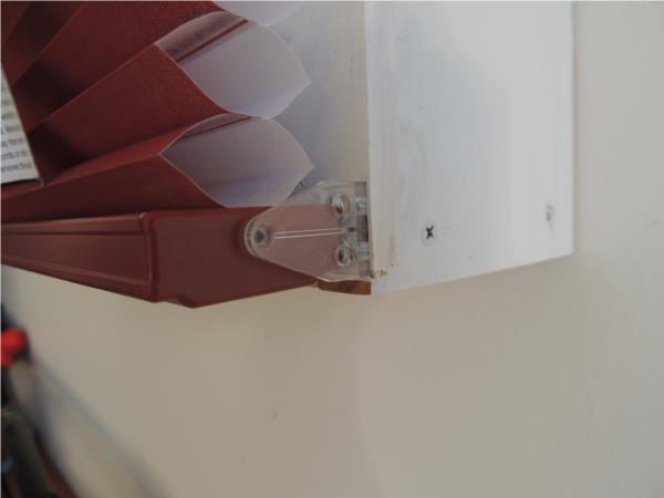 Honeycomb blind clipped into hold down clips